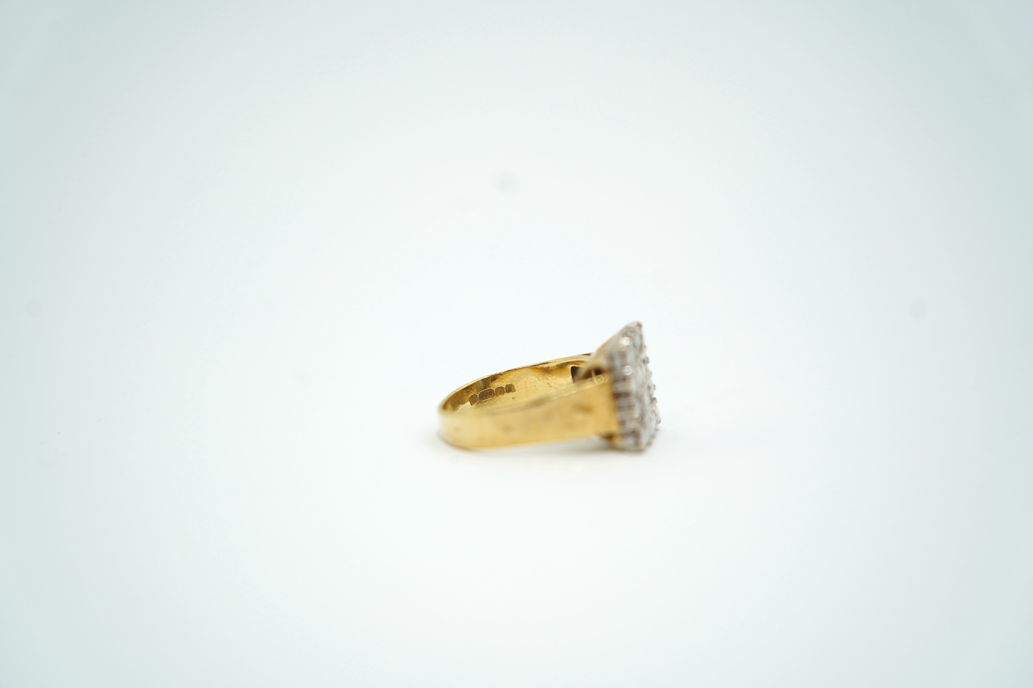 A modern textured 18ct gold and diamond cluster set tablet ring, size K/L, gross weight 6.8 grams.